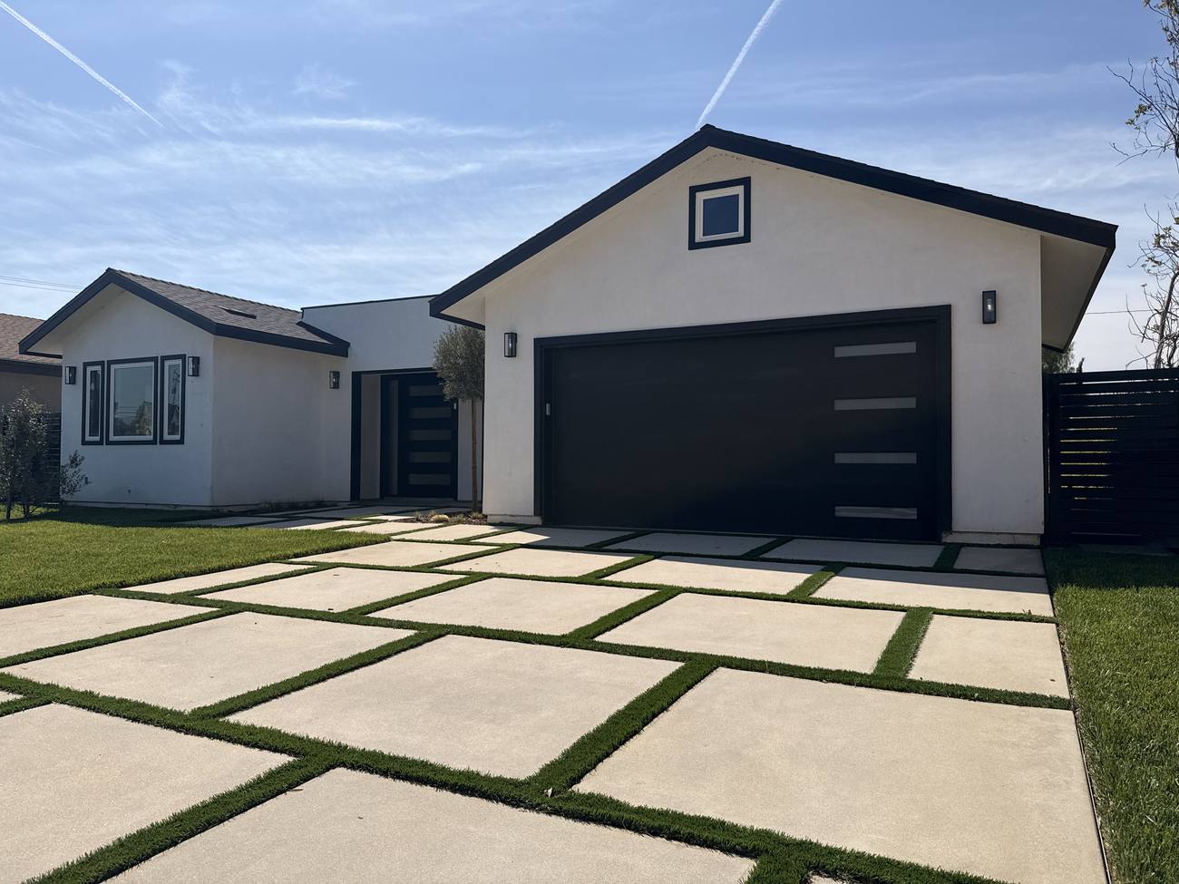 Clean driveway pavers and exterior of a modern home