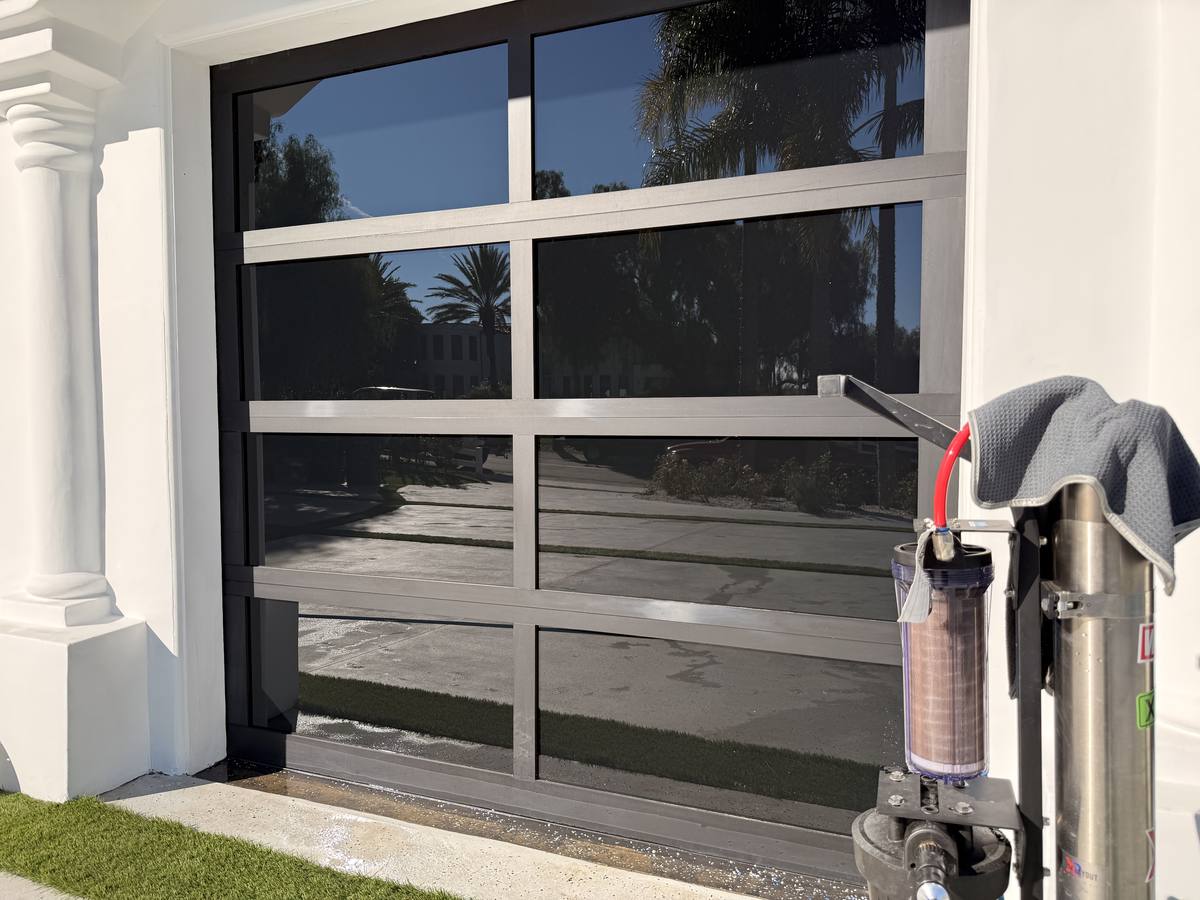 Full-view glass garage door after hard water treatment