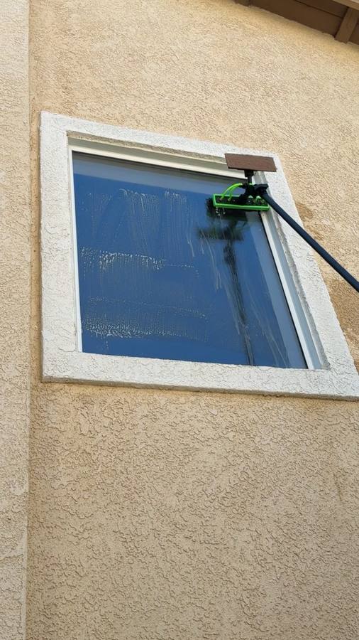 Second story window being scrubbed