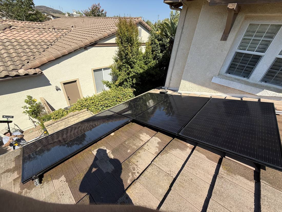 Rooftop solar panels being washed with deionized water
